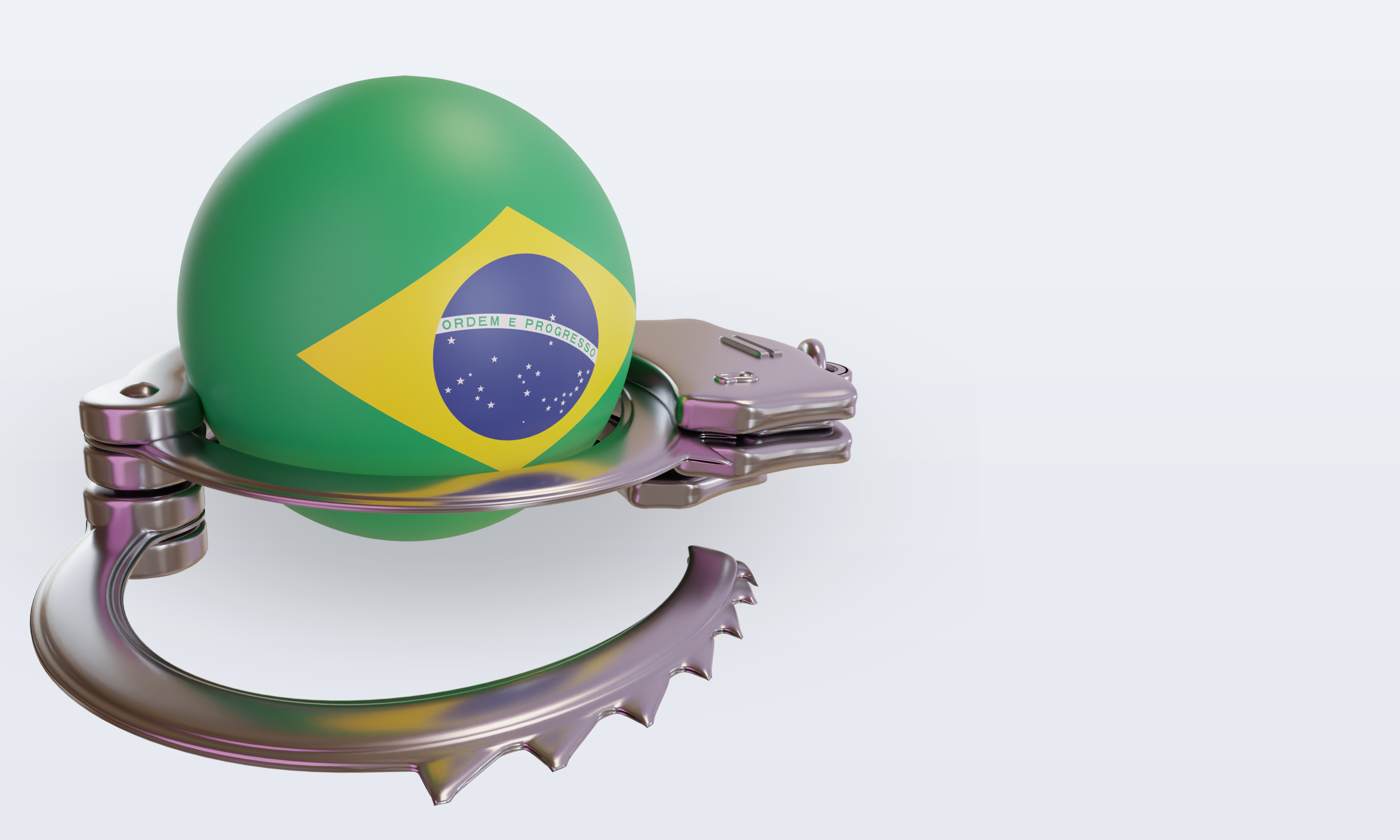 A ball decorated with the Brazil flag is encased by handcuffs.