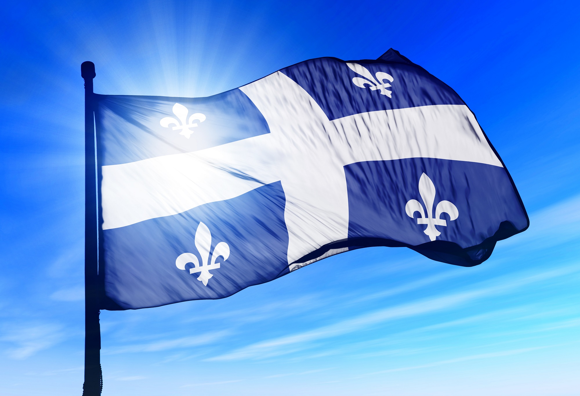 The flag of Quebec, Canada, mounted on a flagpole.