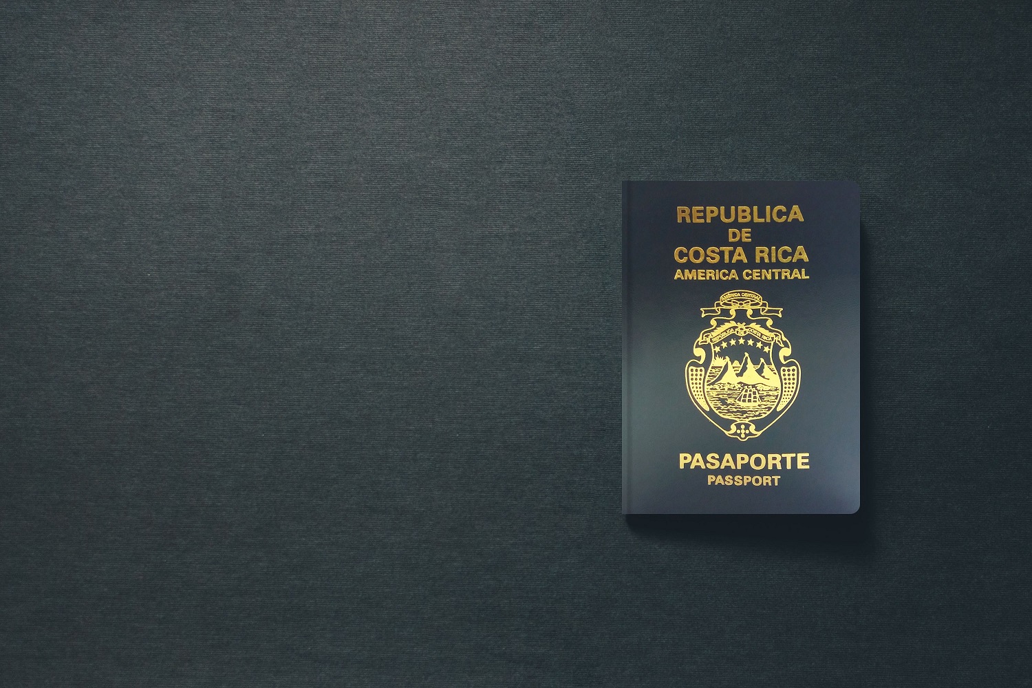 A Costa Rican passport against a dark background.