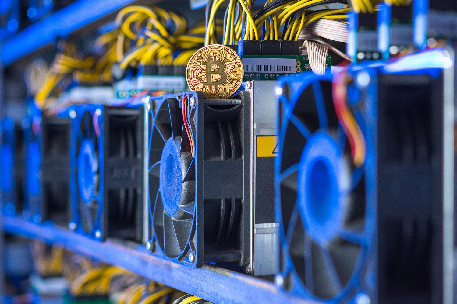 A token intended to represent Bitcoin atop a rig used to mine cryptoassets.