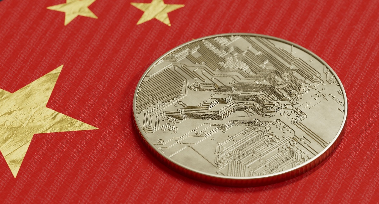 A metal token intended to represent a cryptoasset rests on the flag of China.
