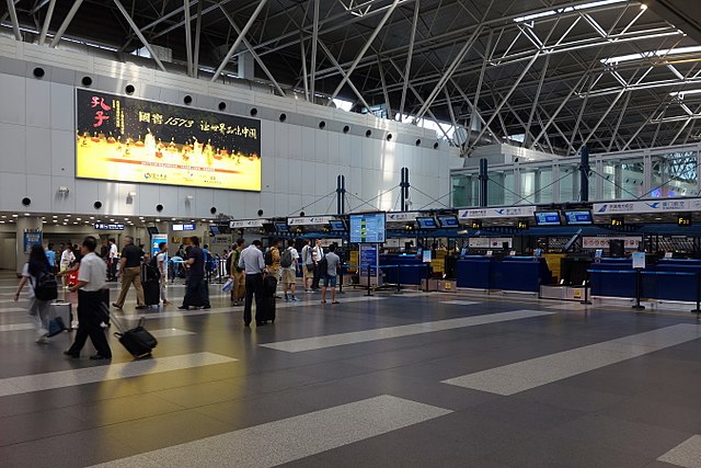 Passengers walk past counters at Beijing Capital International Airport, in Beijing, China.