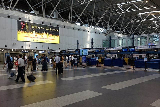 Passengers walk past counters at Beijing Capital International Airport, in Beijing, China.