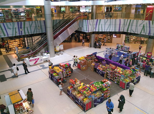 Customers walk through a shopping mall in Hong Kong.