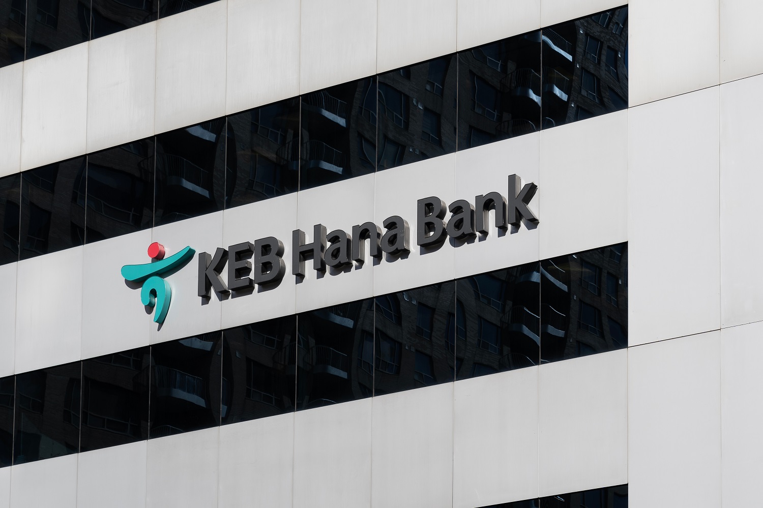 A KEB Hana Bank sign on the side of a building.