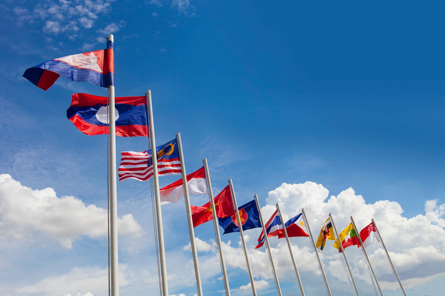 The flags of the ASEAN nations, mounted on flagpoles.