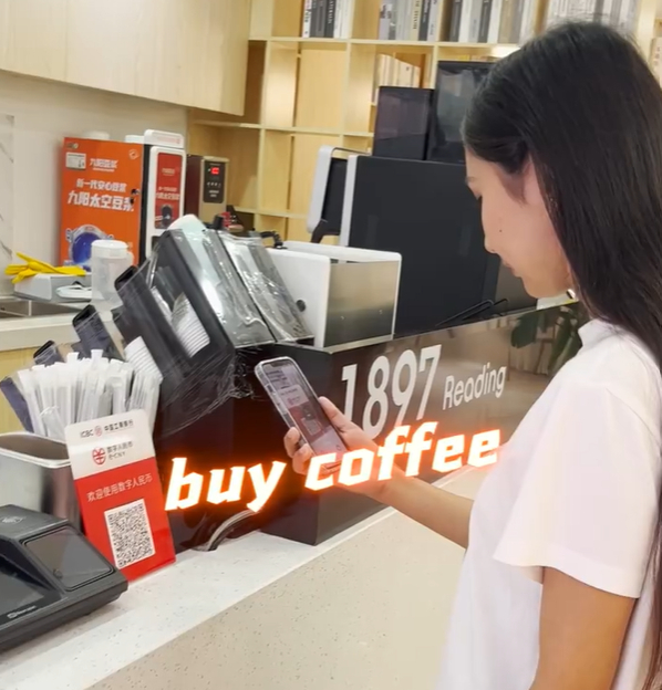 An international student uses the digital yuan to pay in a Chinese coffee shop.