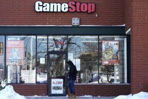 A customer checks his cellphone as he walks to a GameStop store in Vernon Hills, Ill., on Jan. 28, 2021. (AP Photo/Nam Y. Huh)