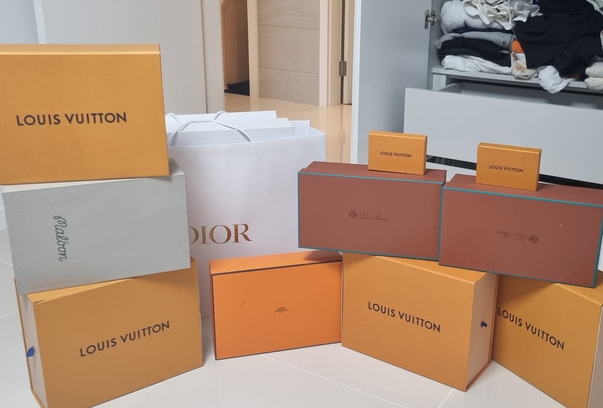 Boxes of luxury goods seized by police during raids on the “fake crypto mining” group’s suspected mastermind.