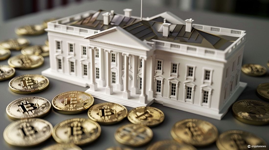 A white model of the White House sits on a grey surface surrounded by gold Bitcoin coins, symbolizing the growing interest in Biden Bitcoin policy, particularly with key figures like Mark Cuban and Ro Khanna involved.