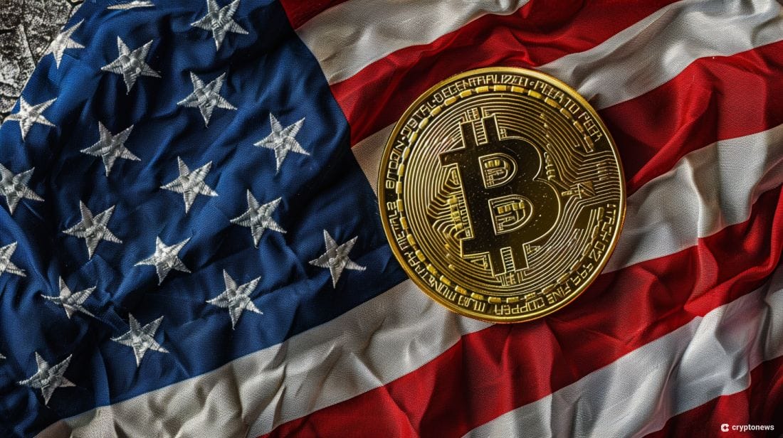 A physical bitcoin coin rests on a United States flag, representing the recent passage of the Blockchain Basics Act, a new bitcoin bill in Louisiana.