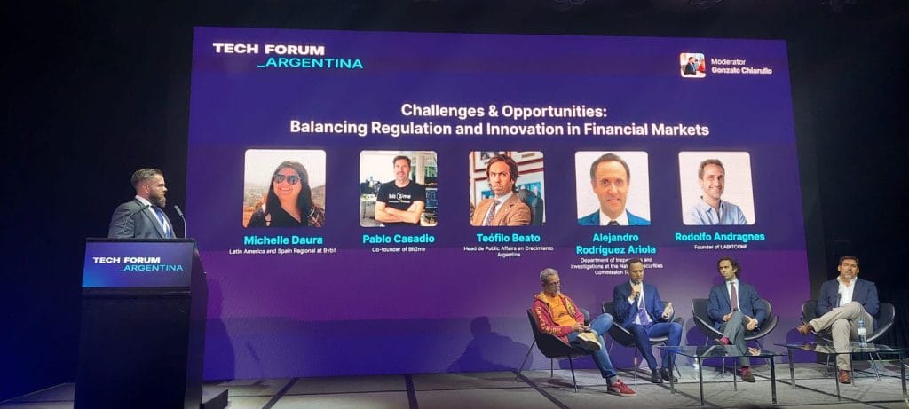 Alejandro Rodríguez Ariola, a lawyer at the Department of Inspections and Investigations, National Securities Commission (seated, second from left), speaks at the Tech Forum summit in Buenos Aires on October 19.