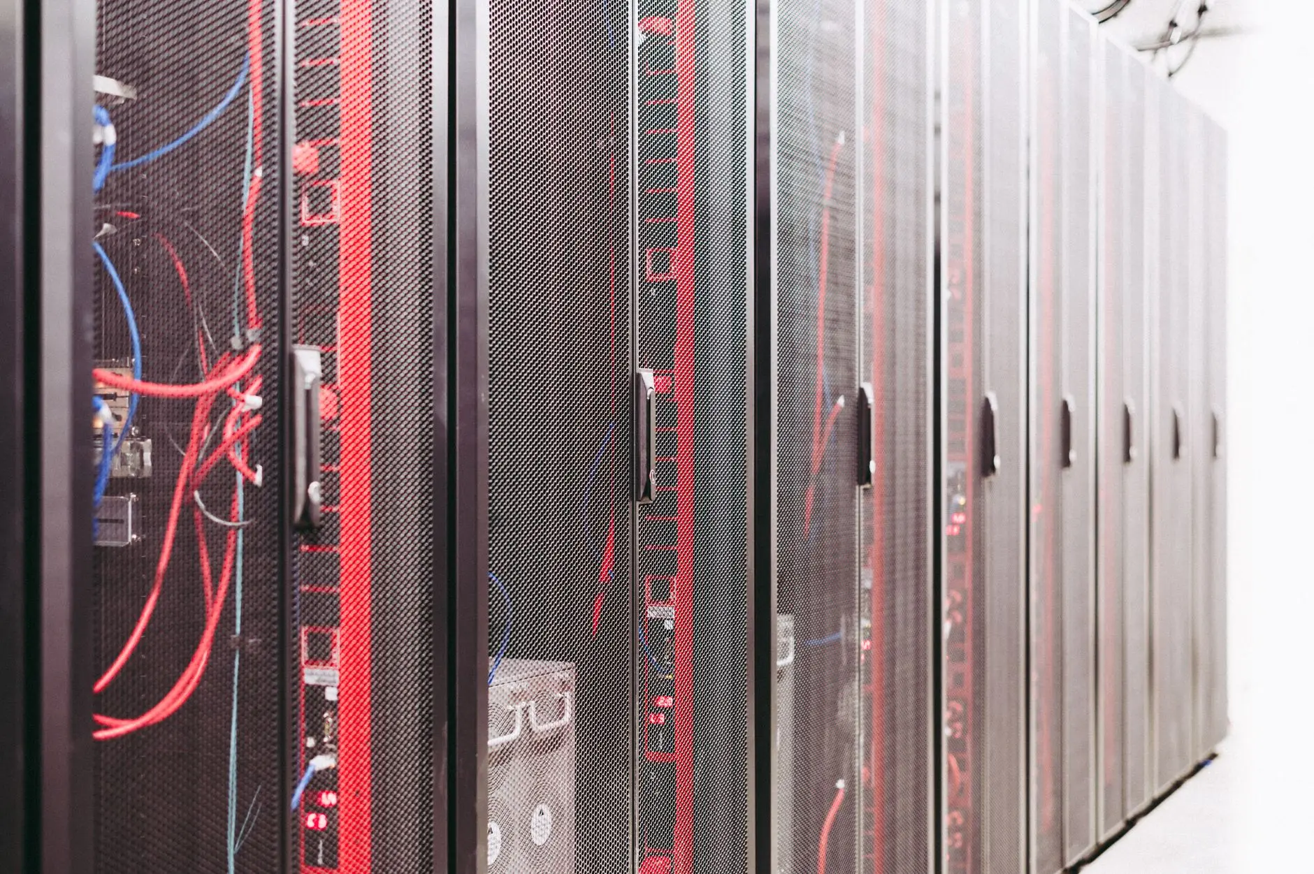 Server racks with visible wiring in a data center environment.
