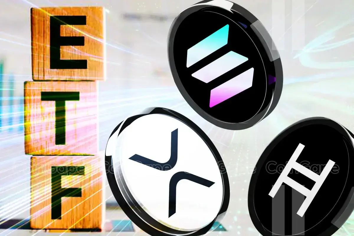Wooden blocks spelling ETF next to Ethereum, XRP, and Hedera coins.