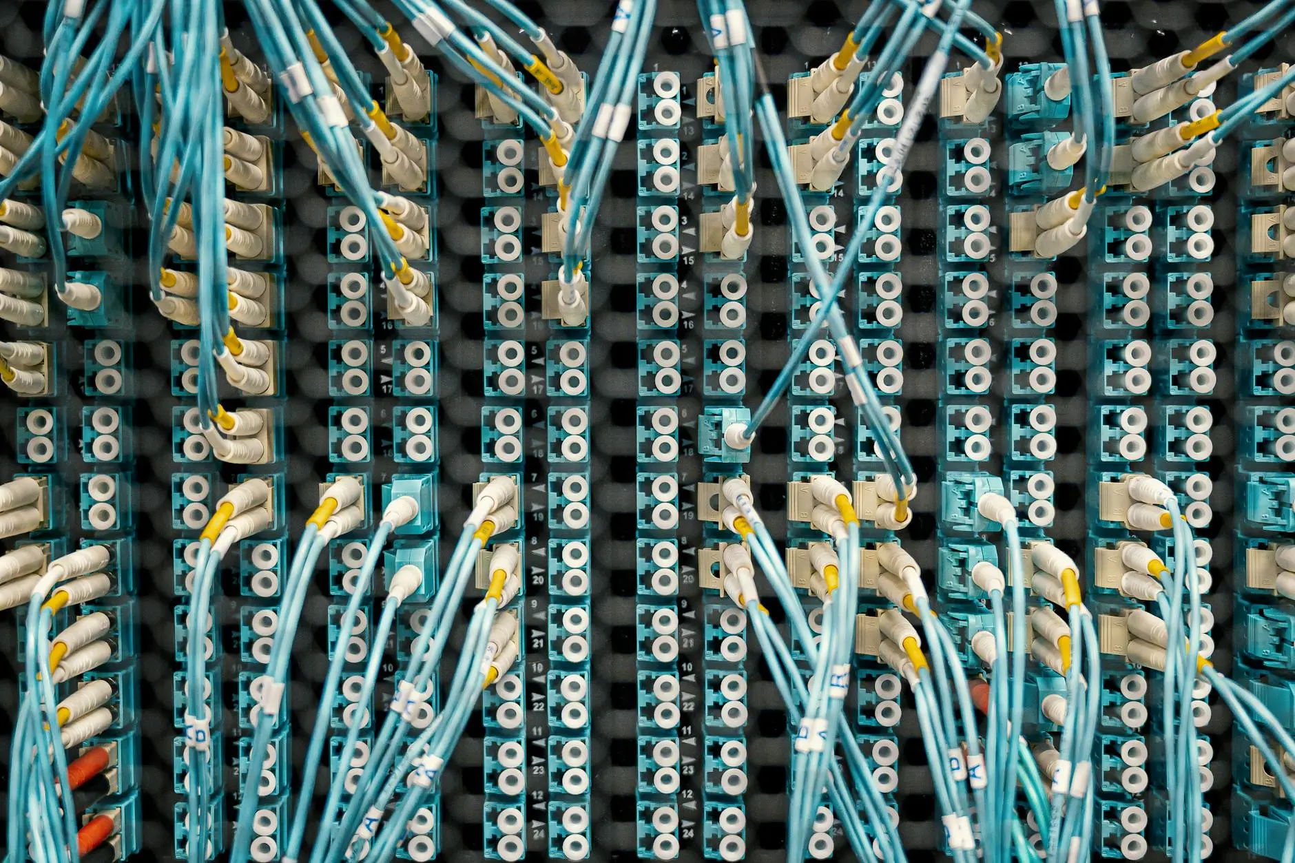 Close-up of a network switch with multiple connected fiber optic cables.