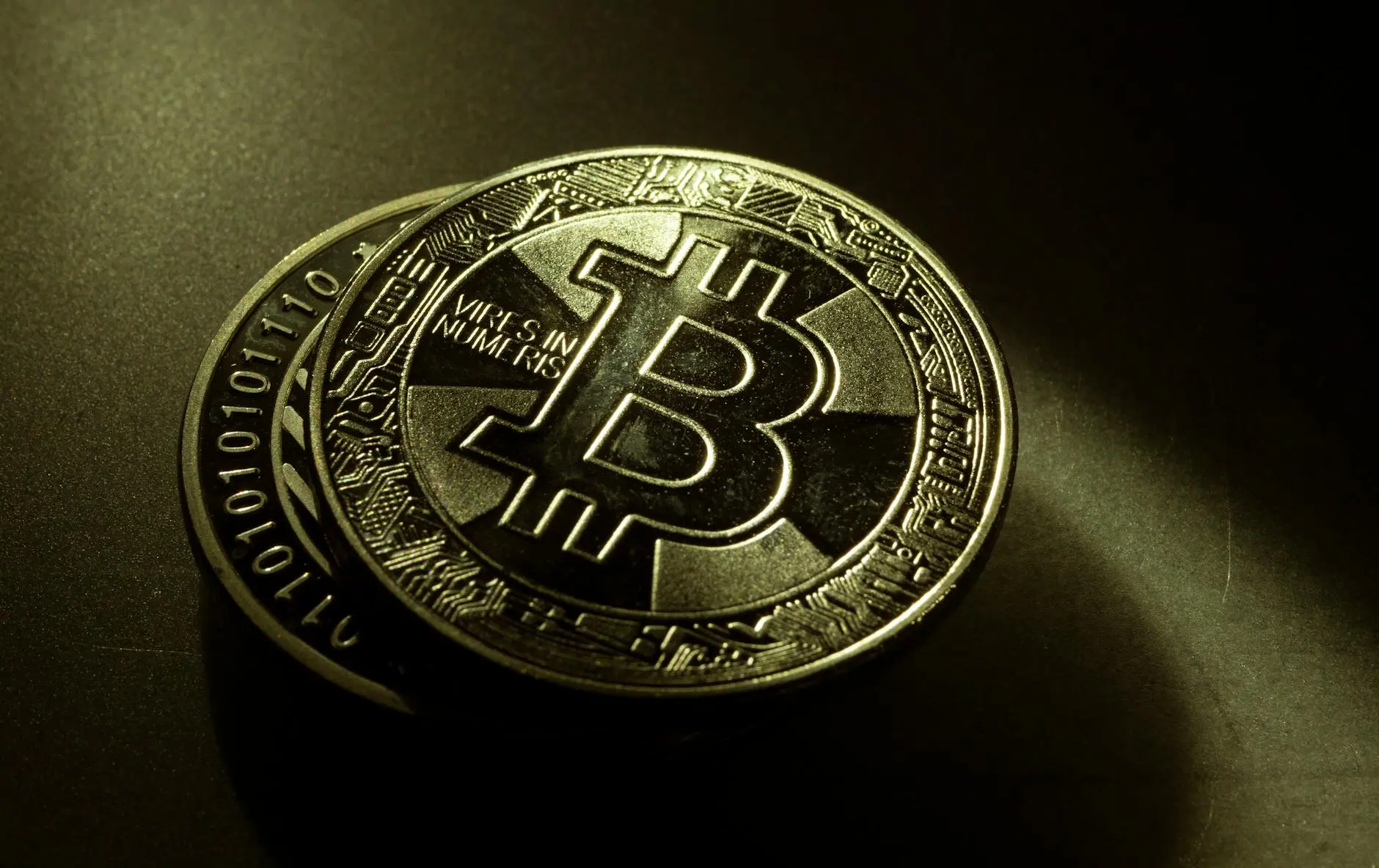 Close-up of a Bitcoin coin featuring intricate designs and inscriptions.