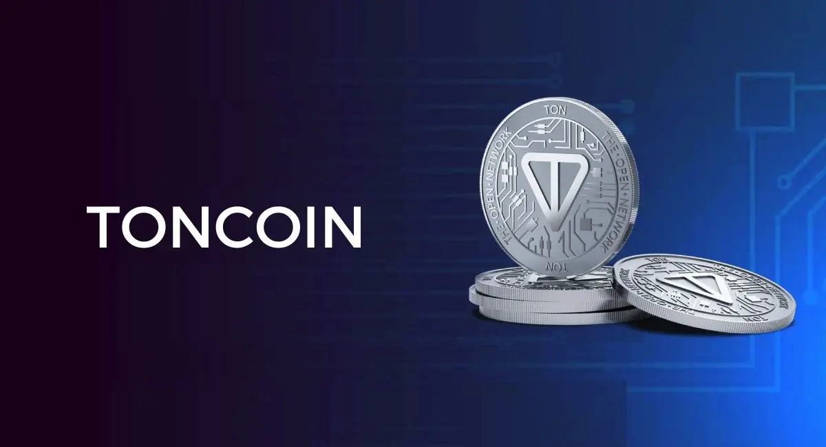 Three silver Toncoin cryptocurrency coins displayed against a digital-themed background.