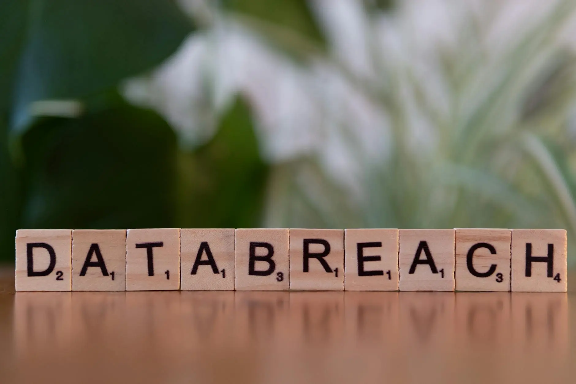 Wooden blocks spelling 'DATABREACH' on a table with a blurred background.