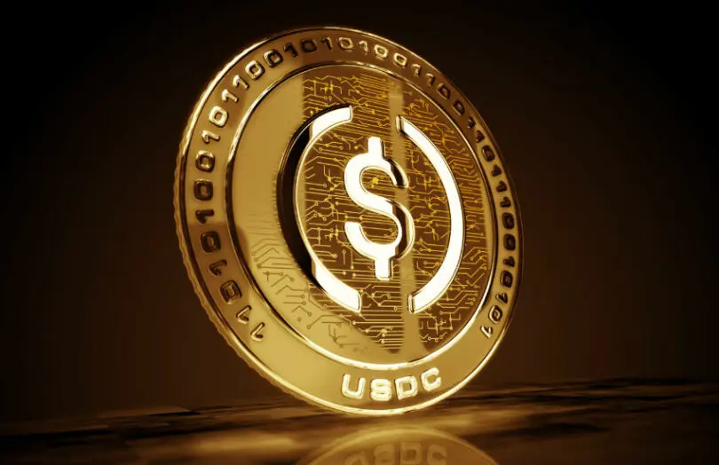 Gold digital coin featuring USDC logo with circuit patterns.
