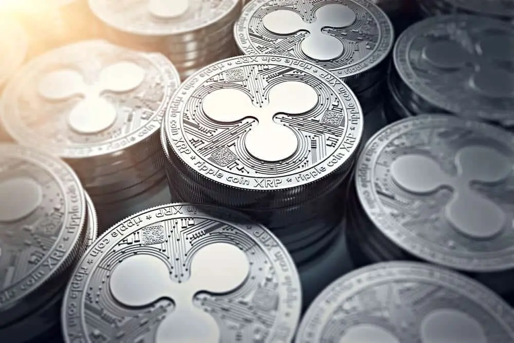 Close-up of multiple physical Ripple XRP coins stacked together.