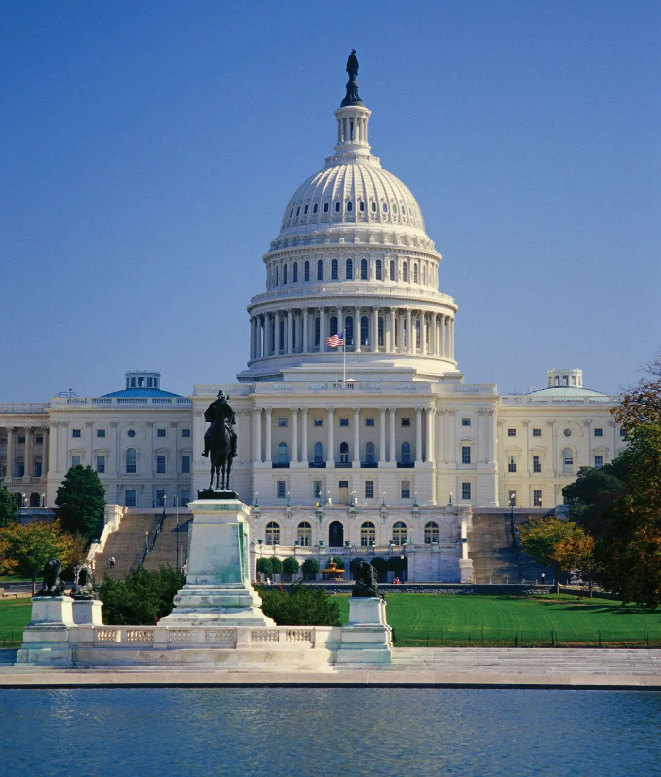 United States Capitol building in Washington, DC, featuring a statue in front.