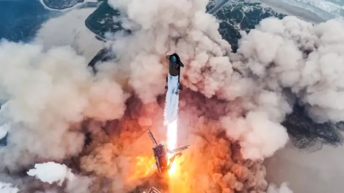 SpaceX Starship rocket launching amidst smoke and fire.