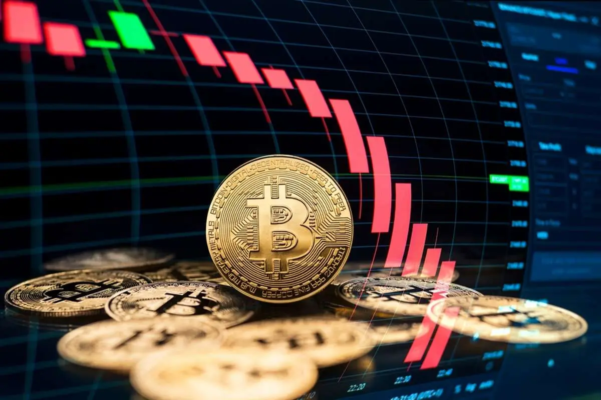 Bitcoin coins in foreground with a trading chart in the background.