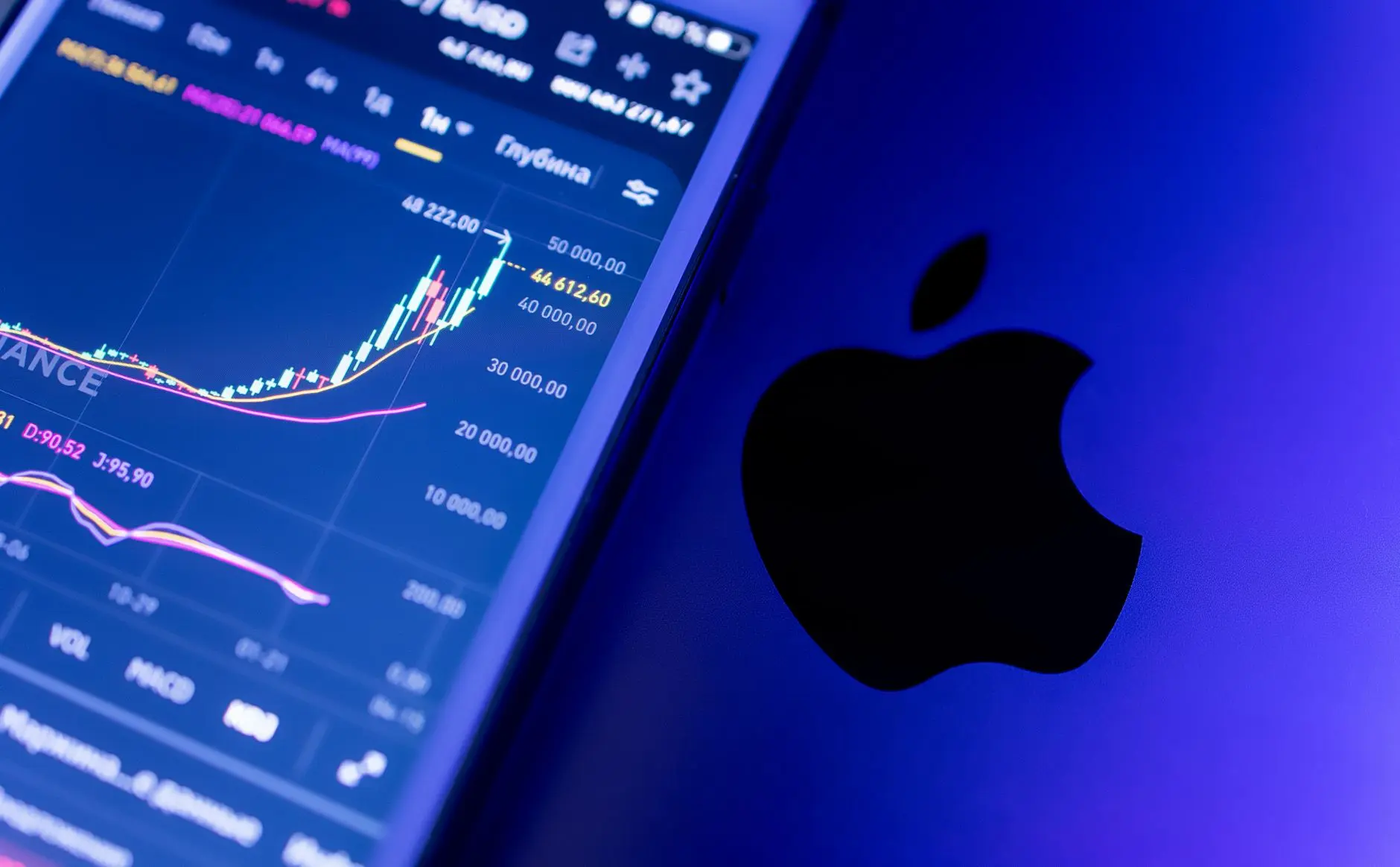A smartphone displaying stock market data alongside an Apple logo.