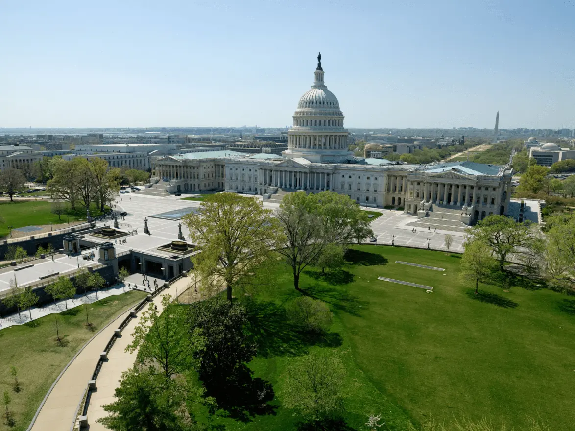 Aerial view of the US Capitol building and surrounding grounds.