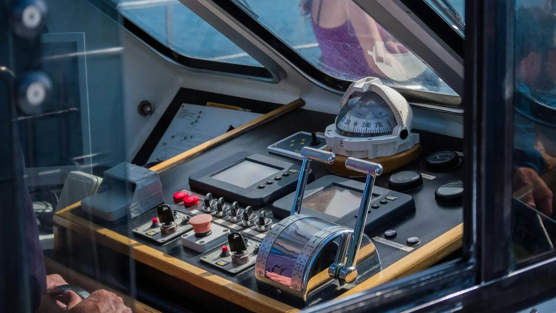 Close-up of a maritime vessel control dashboard with navigation instruments.