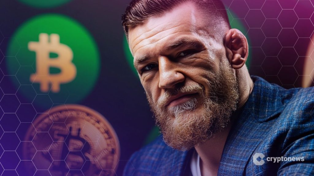 كونور مكجريجور وخلفه شعار معدني لعملة بيتكوين