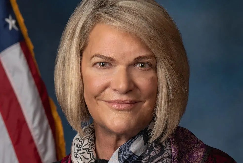 Official portrait of Senator Cynthia Lummis in front of an American flag.